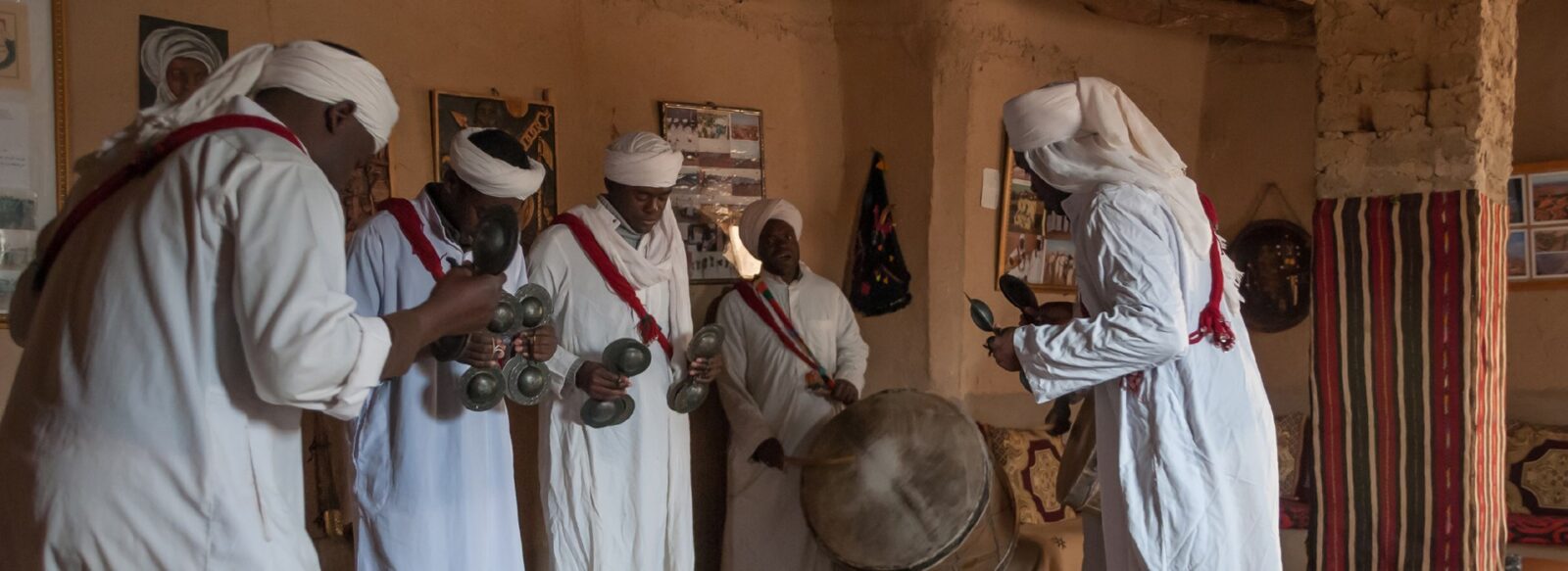 Merzouga, Morocco - march 21, 2012: Gnawa musical group dancing and playing instruments in the village of Khamlia